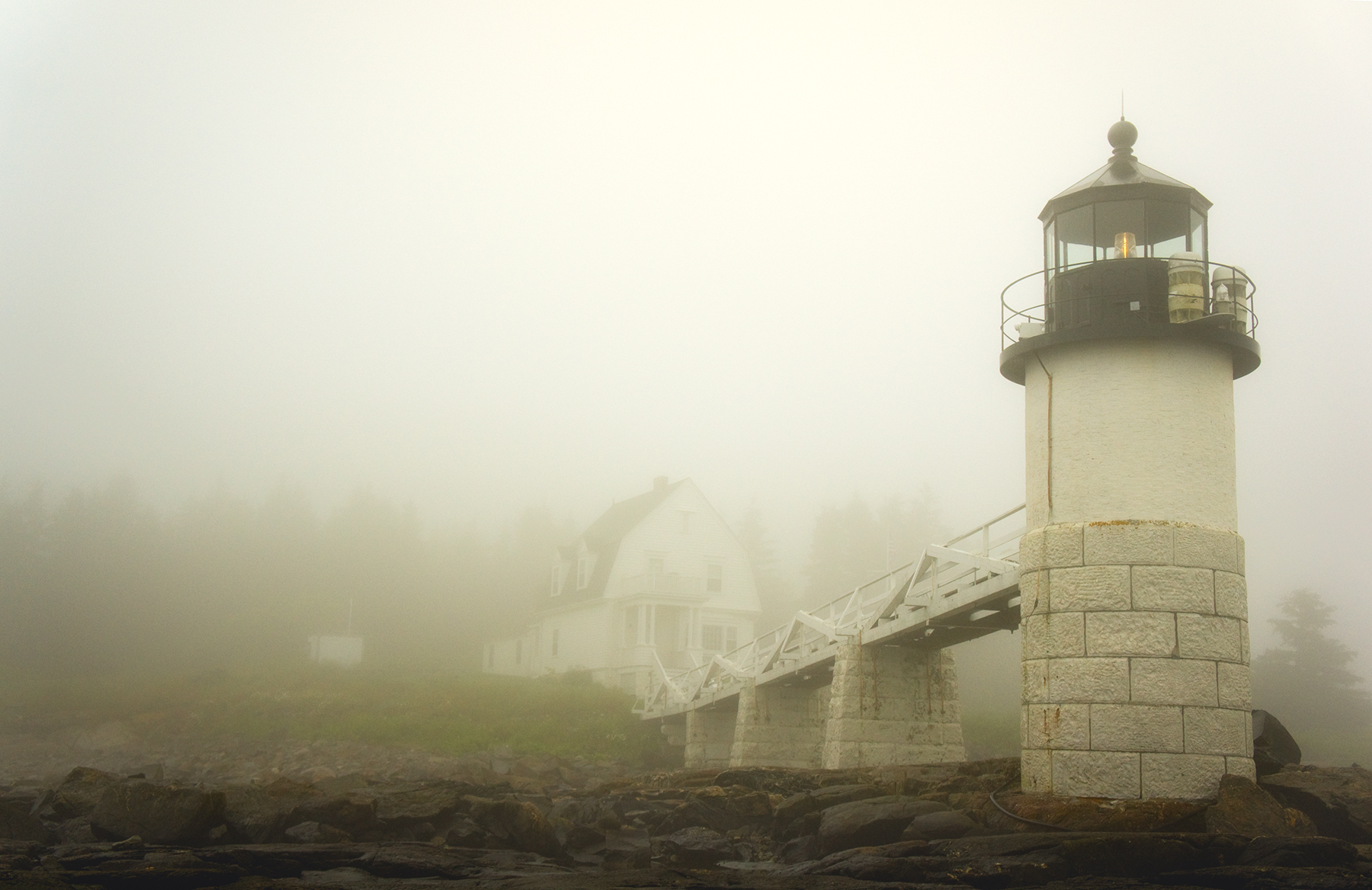 Marshall Point Lighthouse dissolving into dense coastal fog, Maine