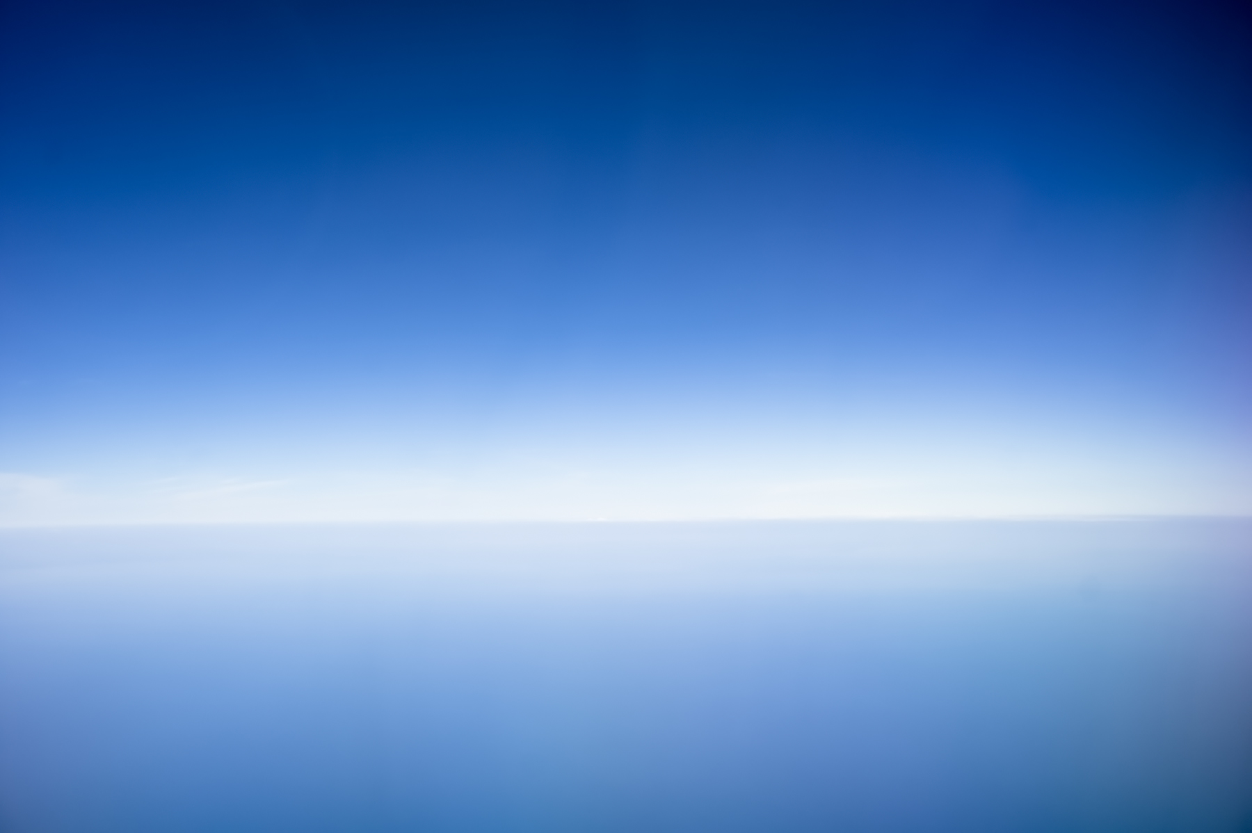Sky dissolving into lake, no visible horizon, infinite blue gradient, Lake Erie