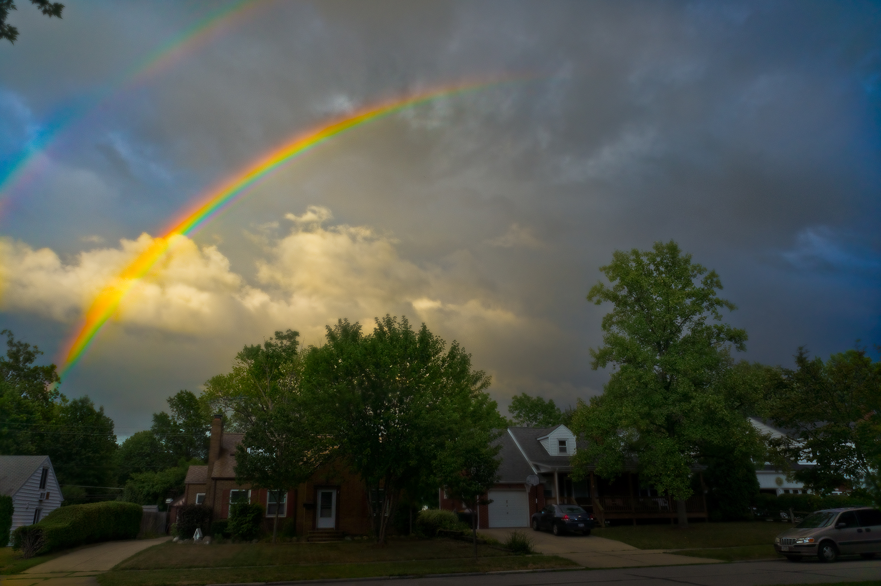 Double rainbow over suburban neighborhood against dramatic storm sky, Willoughby Ohio
