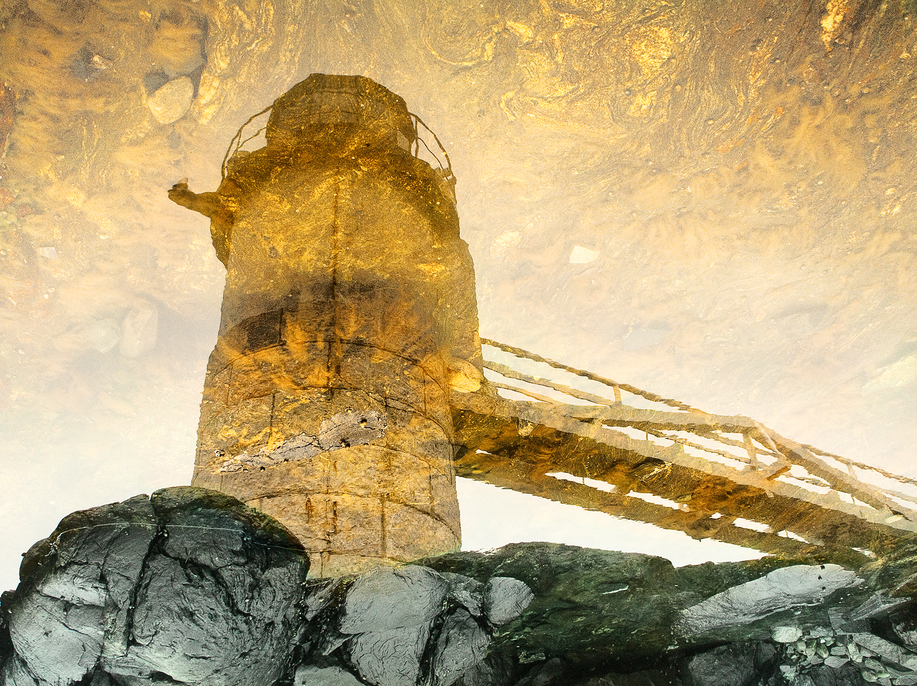 Marshall Point Lighthouse reflected in golden tidal pools, abstract